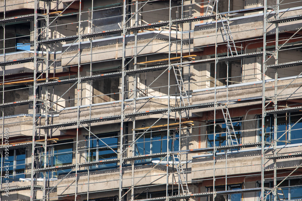 Close-up with a scaffolding on the facade of a block Close-up with a scaffolding on the facade of a block