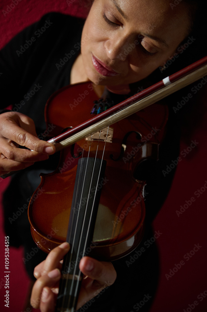 Focused musician playing a violin with deep concentration and passion Focused musician playing a violin with deep concentration and passion