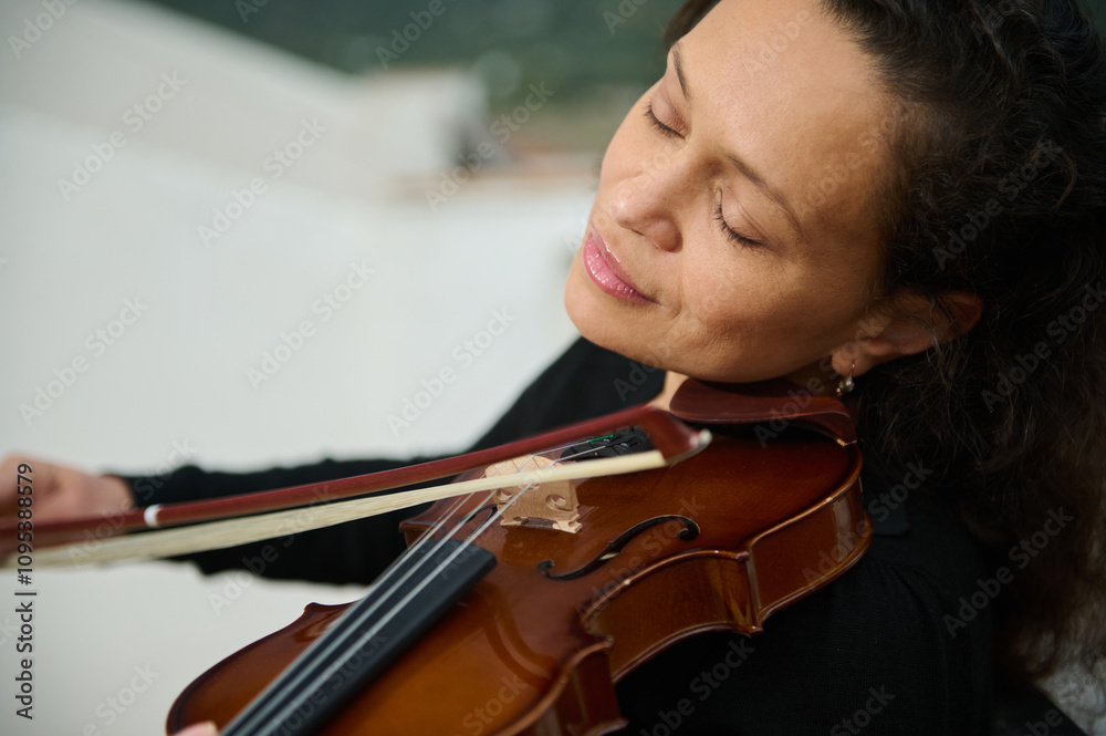 Woman immersed in playing violin with closed eyes Woman immersed in playing violin with closed eyes