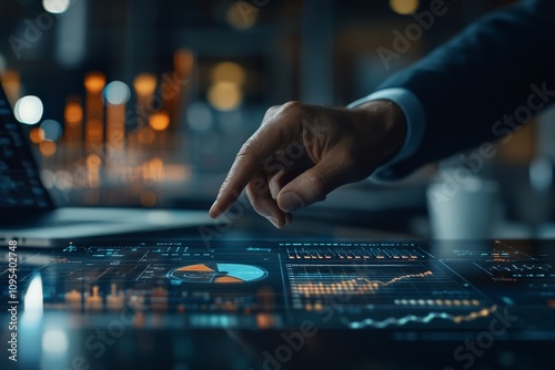 A hand confidently reaches for an interactive digital dashboard displaying various financial charts, indicating tech-savvy and strategic decision making skills. photo