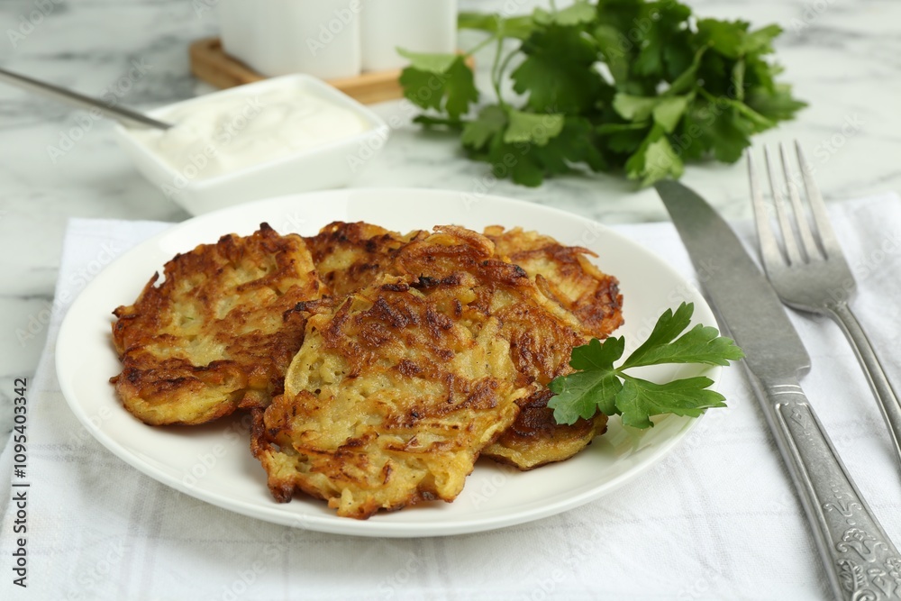 Delicious potato pancakes served on white marble table, closeup Delicious potato pancakes served on white marble table, closeup