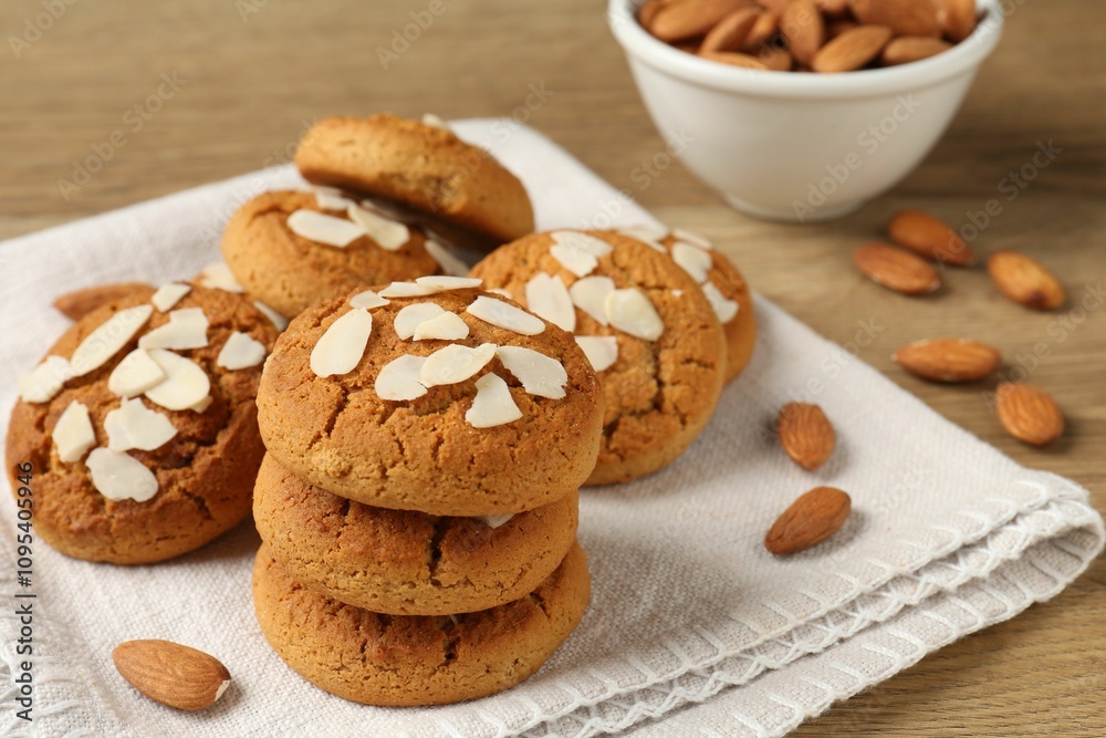 Tasty cookies with almond flakes and nuts on wooden table, closeup Tasty cookies with almond flakes and nuts on wooden table, closeup