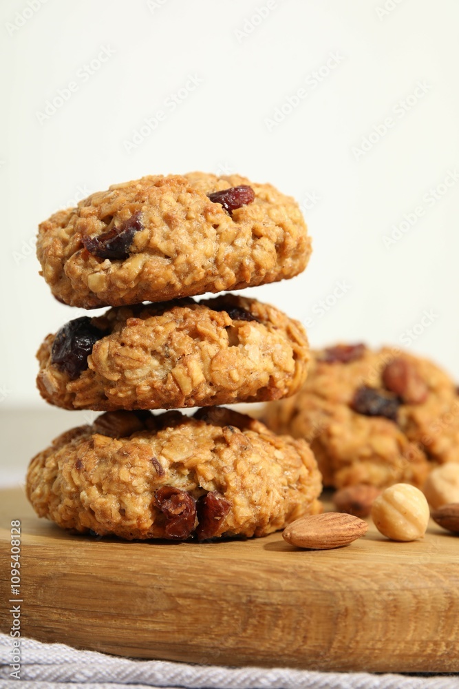 Delicious oatmeal cookies with raisins and nuts on table, closeup Delicious oatmeal cookies with raisins and nuts on table, closeup
