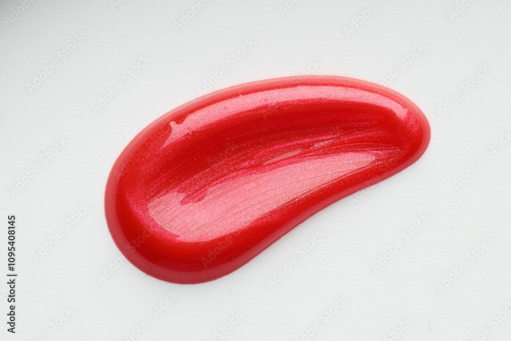 Red lip gloss isolated on white, top view. Sample of cosmetic product