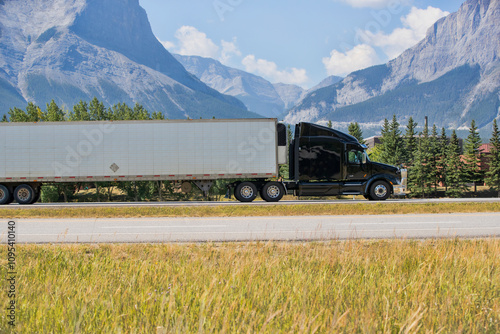 Heavy Cargo on the Road. A truck hauling freight along a highway. Taken in Alberta, Canada