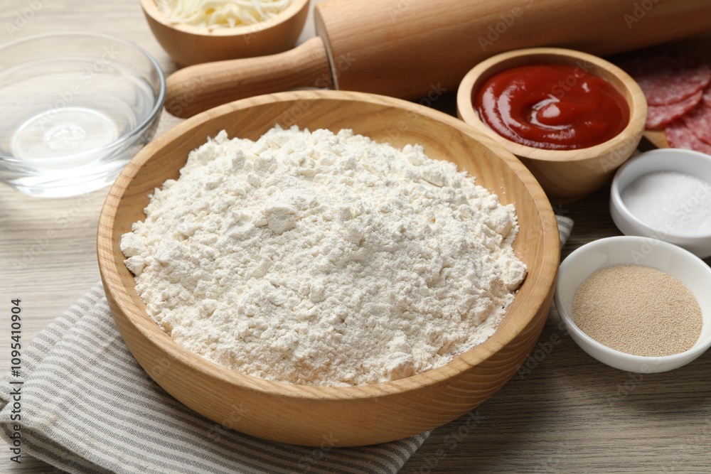 Making calzone pizza. Different ingredients on wooden table, closeup Making calzone pizza. Different ingredients on wooden table, closeup