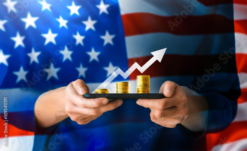 Hands holding a line with coins arranged to symbolize growth, with an upward arrow above them representing prosperity and success. The hands are draped in an American flag, symbolizing economic power