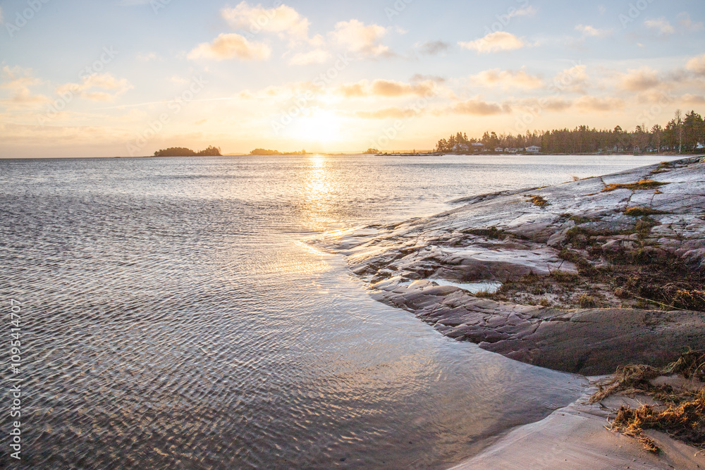 Shore of a lake at sunrise. Landscape shot in the Narur in the morning. Forests lake and water at the beginning of winter or in autumn. Sweden, Scandinavia Shore of a lake at sunrise. Landscape shot in the Narur in the morning. Forests lake and water at the beginning of winter or in autumn. Sweden, Scandinavia
