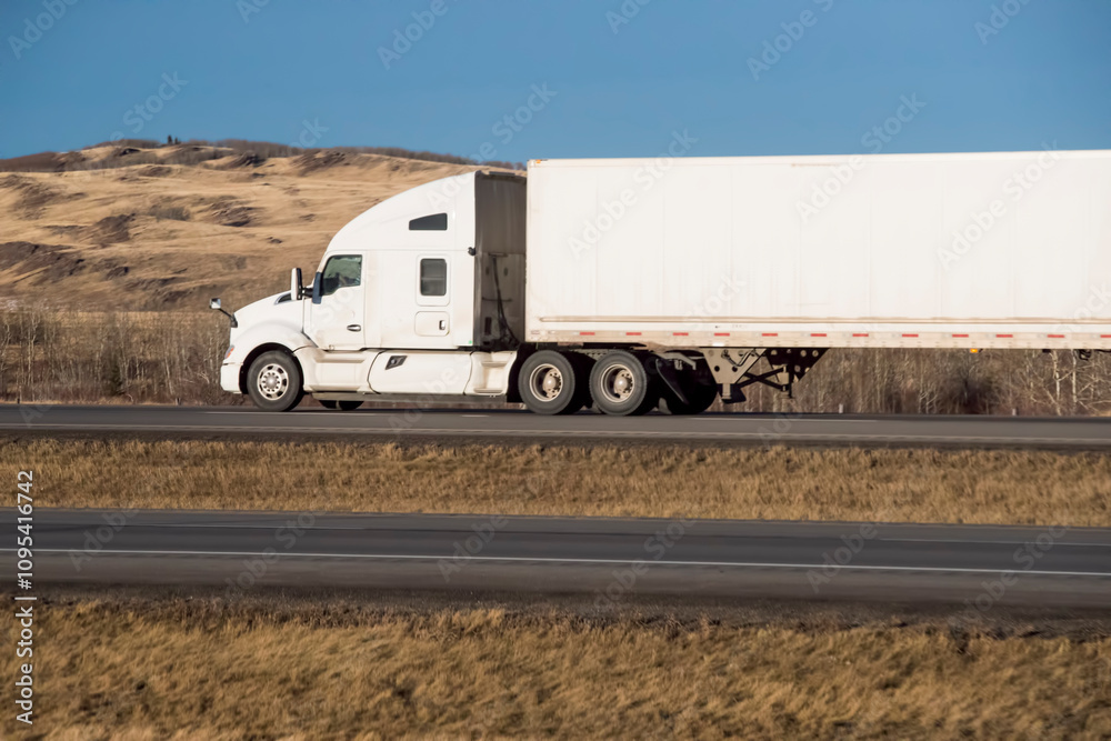 Heavy Cargo on the Road. A truck hauling freight along a highway. Taken in Alberta, Canada Heavy Cargo on the Road. A truck hauling freight along a highway. Taken in Alberta, Canada
