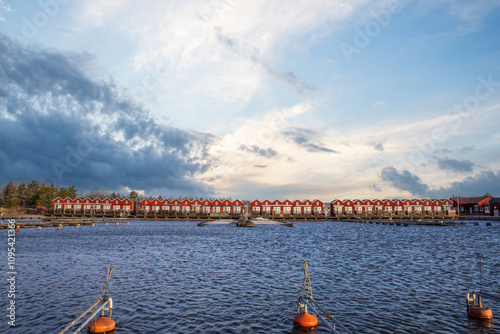 Harbor by the lake, landscape shot in autumn. Holiday village and harbor on the water in Sunnana Hamn in Sweden photo