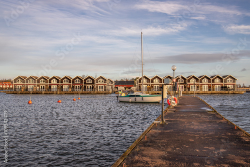 Harbor by the lake, landscape shot in autumn. Holiday village and harbor on the water in Sunnana Hamn in Sweden photo