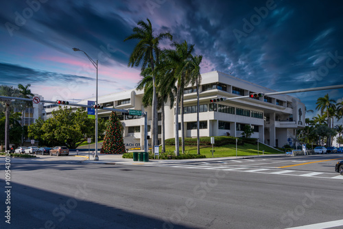 Miami Beach City Hall with lush green palm trees and cars on the street in Miami Beach Florida USA photo