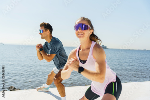 Outdoor workout session by the waterfront showcasing two energetic individuals exercising together