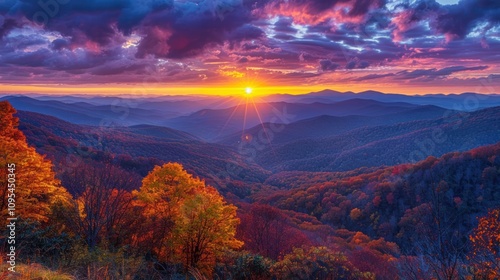 A vibrant sunset over rolling mountains, showcasing autumn colors and dramatic clouds.