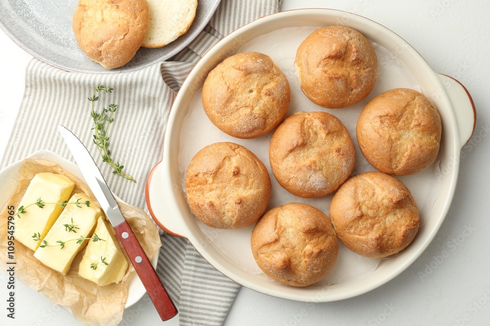Flat lay composition with homemade tasty buns and butter on white table Flat lay composition with homemade tasty buns and butter on white table