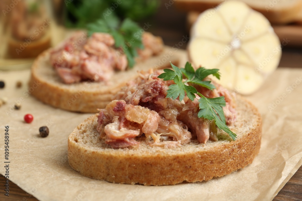 Sandwiches with canned meat, parsley, garlic and peppercorns on table, closeup Sandwiches with canned meat, parsley, garlic and peppercorns on table, closeup