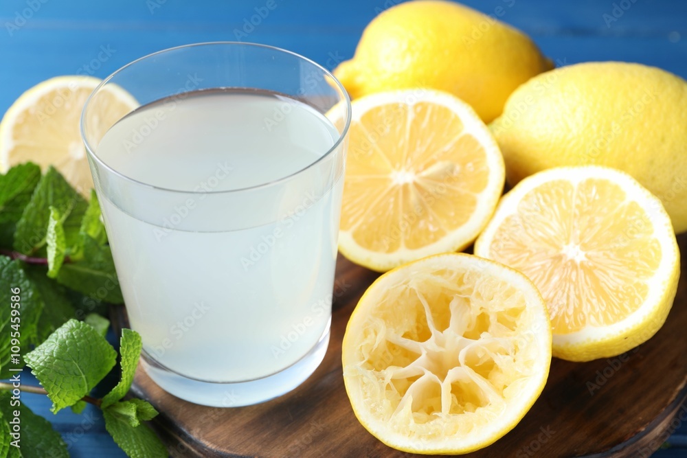Fresh juice in glass, lemons and mint on table, closeup Fresh juice in glass, lemons and mint on table, closeup