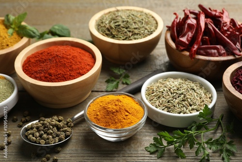 Different aromatic spices on wooden table, closeup