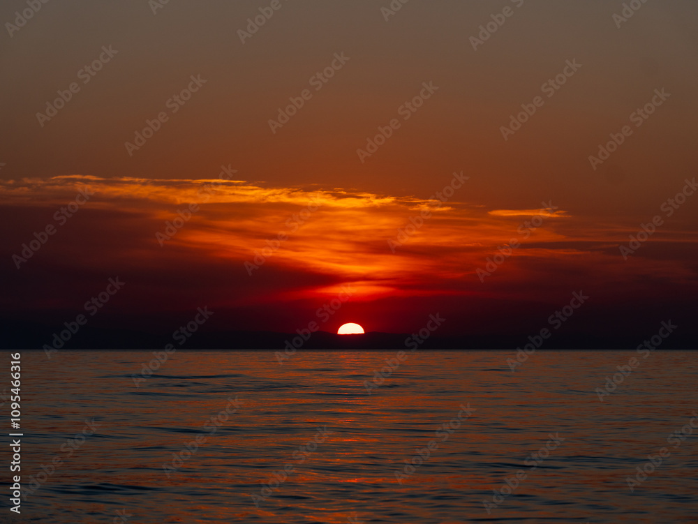 A breathtaking sunset unfolds over the tranquil ocean, with warm orange and red hues illuminating the sky as the sun descends toward the horizon. Soft waves reflect the colors beautifully. A breathtaking sunset unfolds over the tranquil ocean, with warm orange and red hues illuminating the sky as the sun descends toward the horizon. Soft waves reflect the colors beautifully.