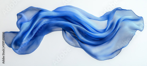 Flowing blue fabric creates an artistic display with gentle waves and transparency, highlighting its delicate texture.