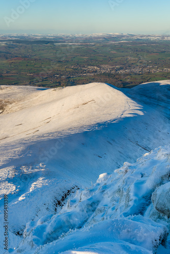 Snow covered ridge leading to Cwm Gwdi on the north face of Pen-y-Fan in the Brecon Beacons, Wales photo