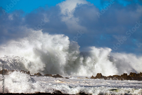 Rushing waves rolling over rocky island patch