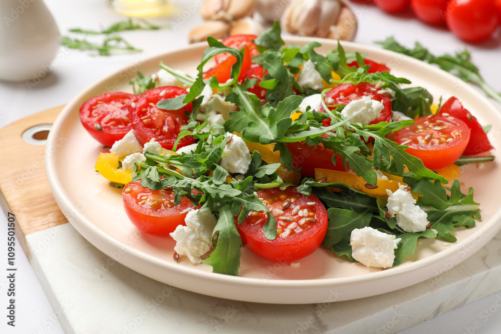 Tasty salad with arugula, cheese and vegetables on white table, closeup Tasty salad with arugula, cheese and vegetables on white table, closeup