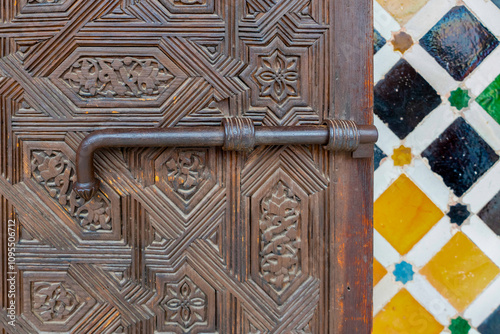 Antique wooden door and metal door bolt at Alhambra palace,  Granada, Andalusia, Spain photo