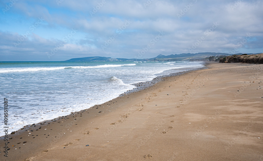 Peaceful sandy beach and calm ocean New Zealand beautiful nature Peaceful sandy beach and calm ocean New Zealand beautiful nature