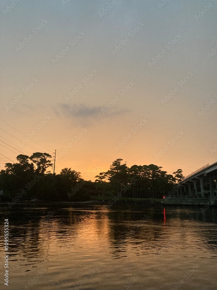 Naklejka premium sunset over the river