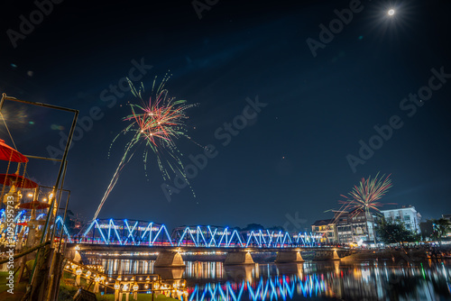  fireworks show at iron bridge across ping river where decorate with a lot of colorful light lanterns is highlight of yee peng loy krathong festival chiangmai thailand November 2024