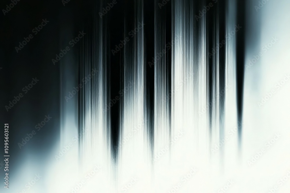 The image is a blurry, black and white photo of a forest with long, thin trees