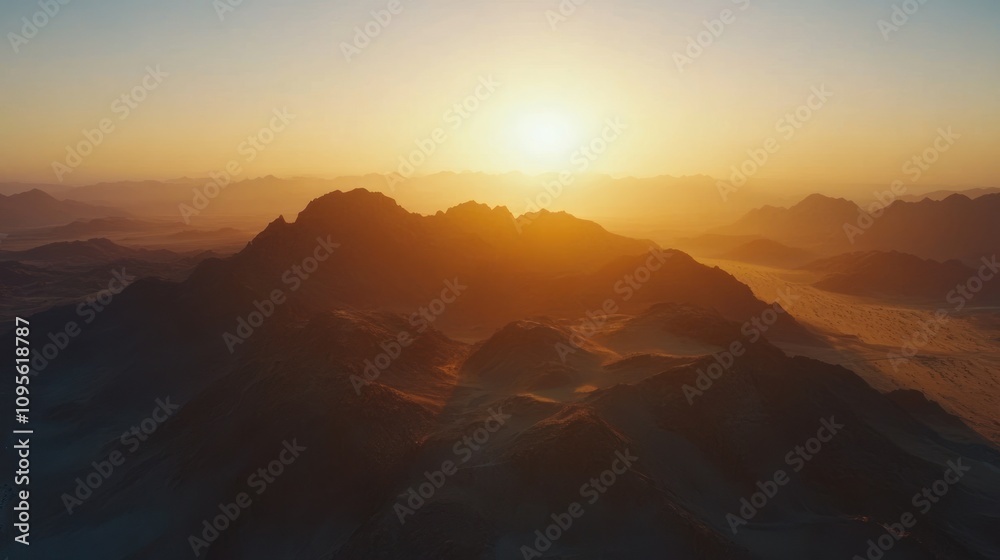 Golden sunset over a desert landscape with distant mountain ranges. Golden sunset over a desert landscape with distant mountain ranges.