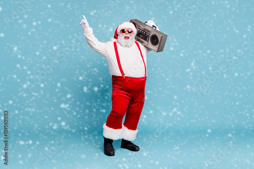 Full length body size view of his he nice cool bearded cheerful cheery Santa carrying vintage cassette player dancing having fun isolated on bright vivid shine vibrant blue turquoise color background