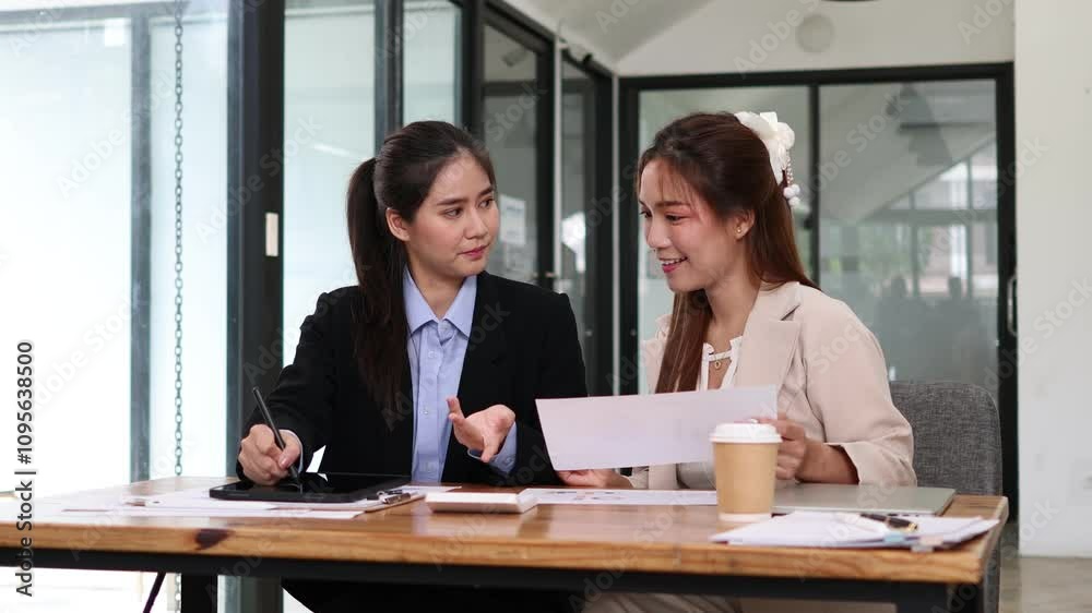 Group of confident business people point to graphs and charts to analyze market data, balance sheet, account, net profit to plan new sales strategies to increase production capacity. Group of confident business people point to graphs and charts to analyze market data, balance sheet, account, net profit to plan new sales strategies to increase production capacity.