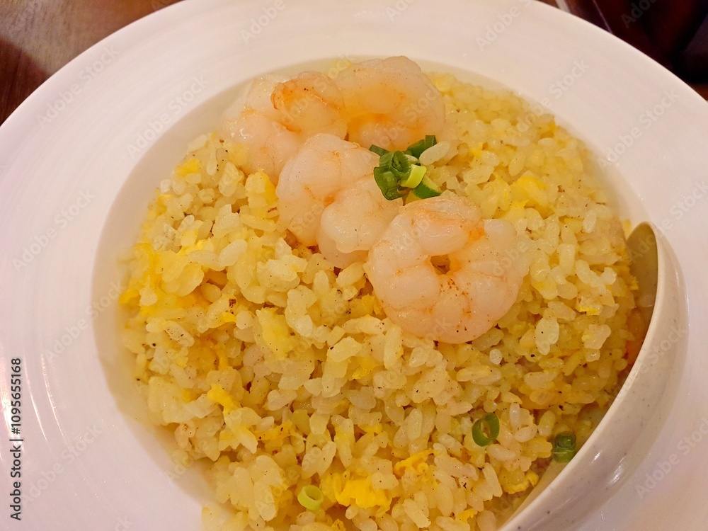 Chinese shrimp fried rice. Flatlay shrimp fried rice served on a white plate on a marble top table. It is served in most Chinese restaurant in asian countries Chinese shrimp fried rice. Flatlay shrimp fried rice served on a white plate on a marble top table. It is served in most Chinese restaurant in asian countries