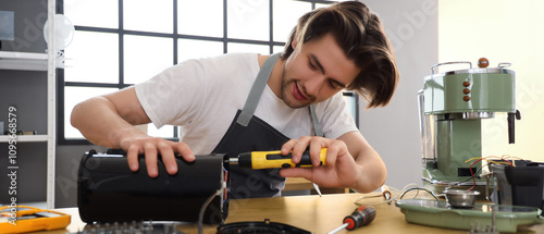 Male worker with screwdrive...