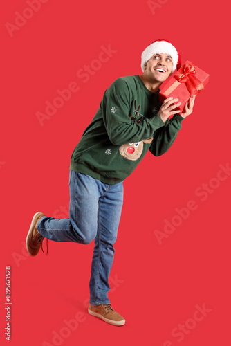 Young man in Santa hat and ...