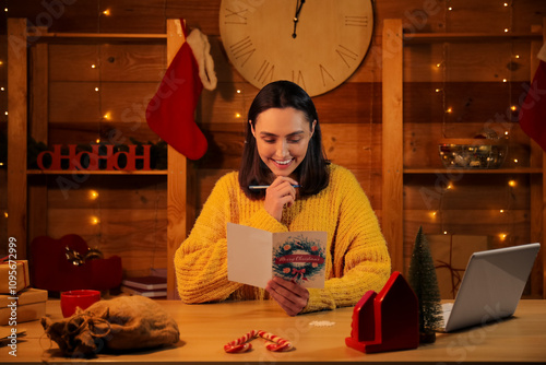 Happy young woman writing C...