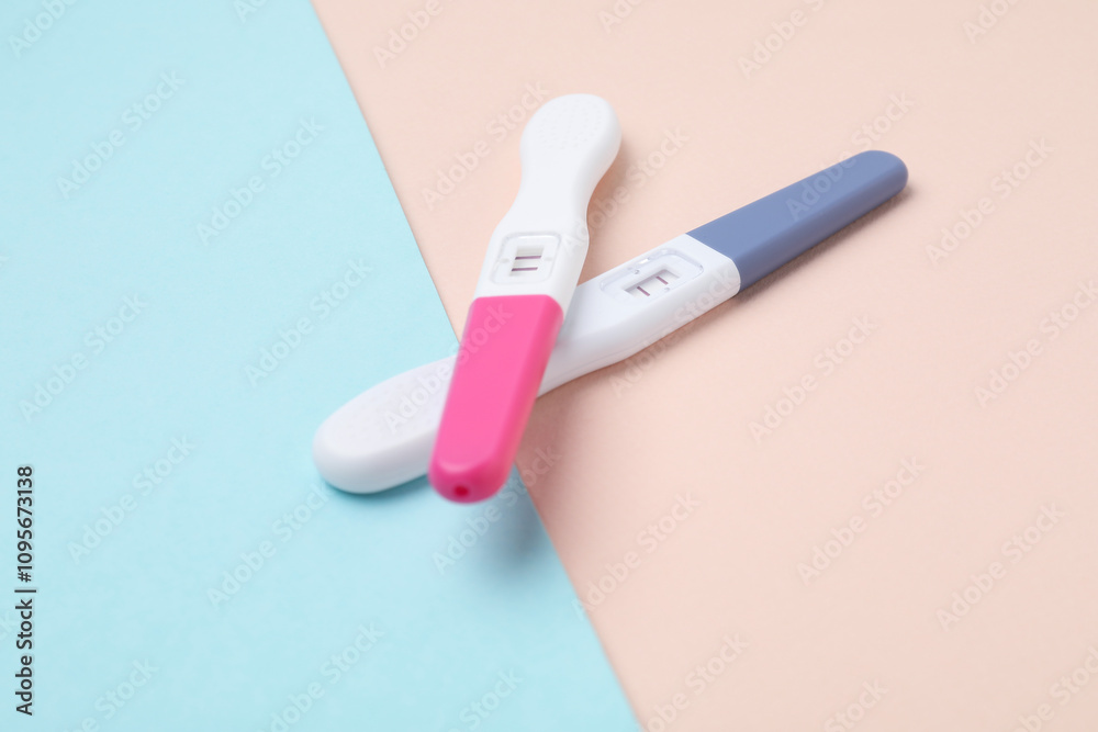 Two pregnancy tests on color background, closeup Two pregnancy tests on color background, closeup