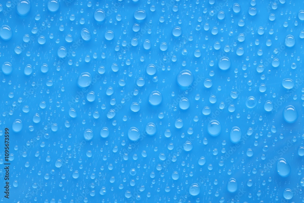 Water drops on blue background, top view Water drops on blue background, top view