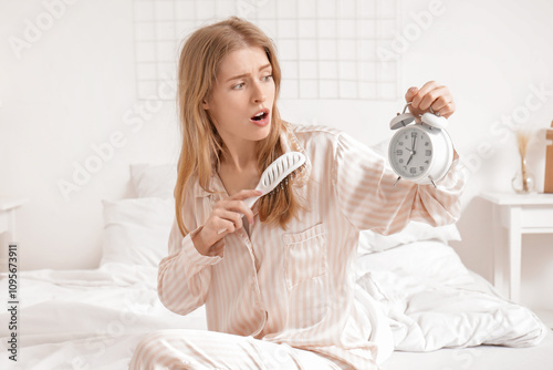 Shocked young woman holding...