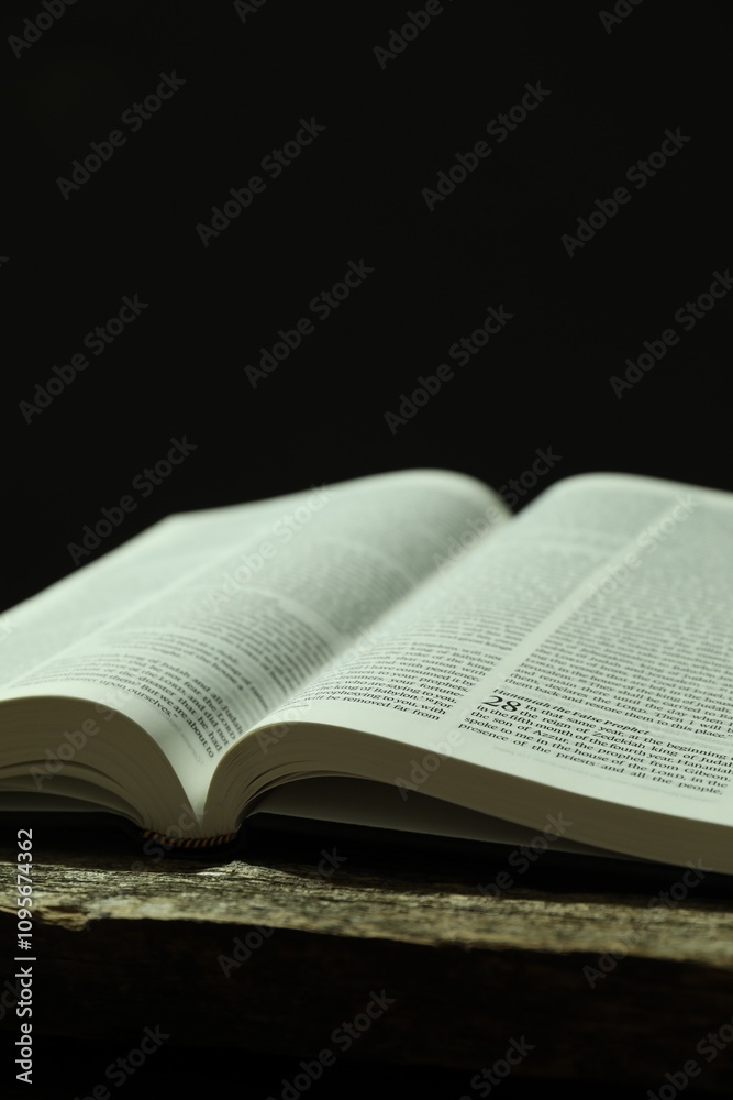 Open Holy Bible in English language on wooden table, closeup Open Holy Bible in English language on wooden table, closeup