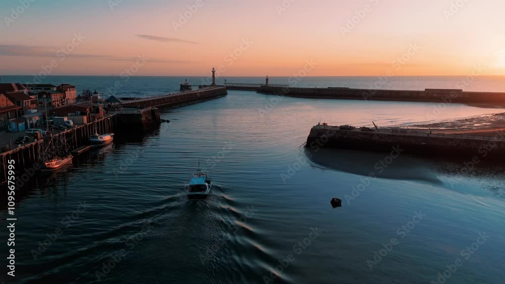 Drone Shot of Working Fishing Boat leaving Whitby Harbour at Sunrise UK Drone Shot of Working Fishing Boat leaving Whitby Harbour at Sunrise UK