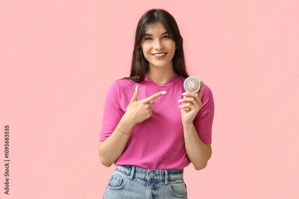 Young woman with mini fan on pink background Young woman with mini fan on pink background