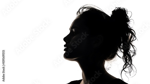 A silhouette of a woman in profile against a bright background, emphasizing her features and hairstyle.