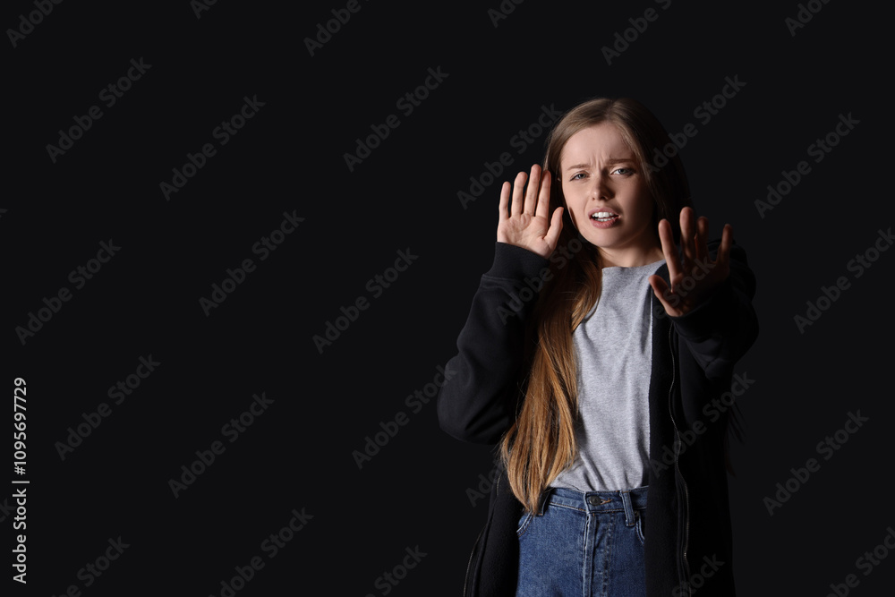 Young woman having panic attack on black background Young woman having panic attack on black background