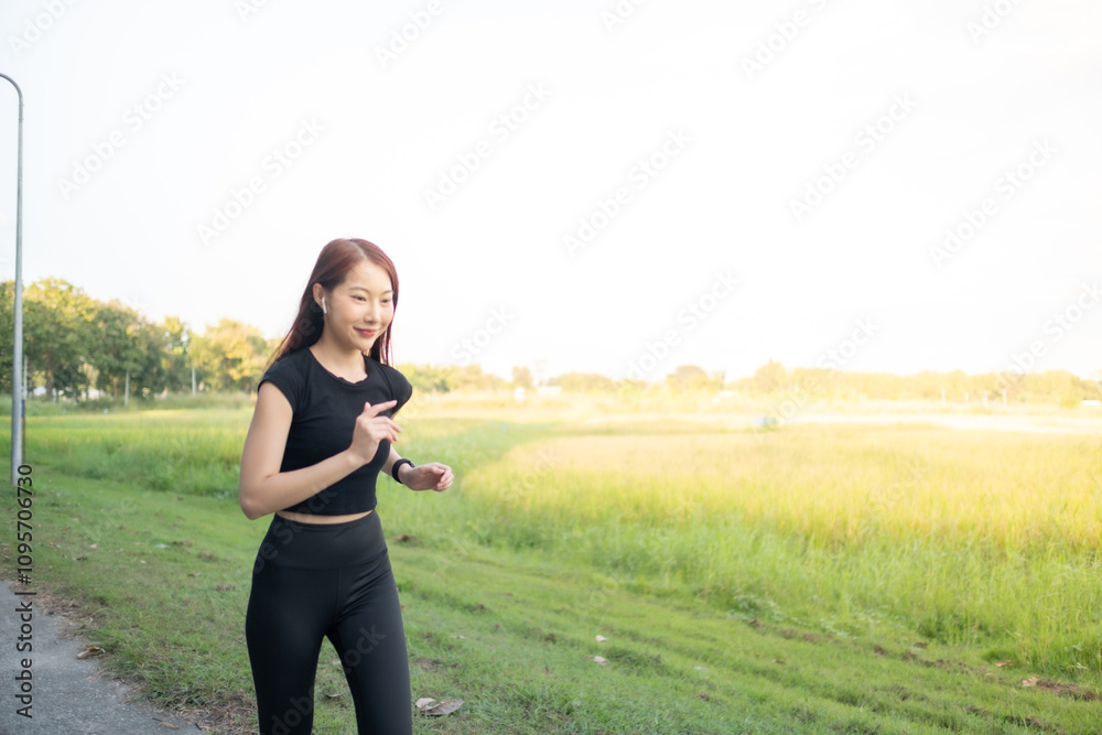 A woman is running in a field with a bright sunny day A woman is running in a field with a bright sunny day