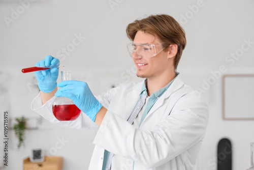Male student in lab coat co...