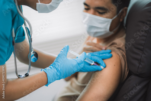 A Healthcare workers wearing protective masks prepare to administer vaccines. Patients receive shots. Detailed and safe medical procedures.